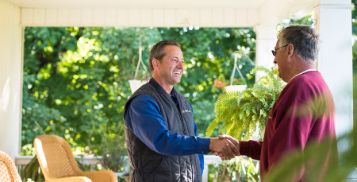 Two men shaking hands outside