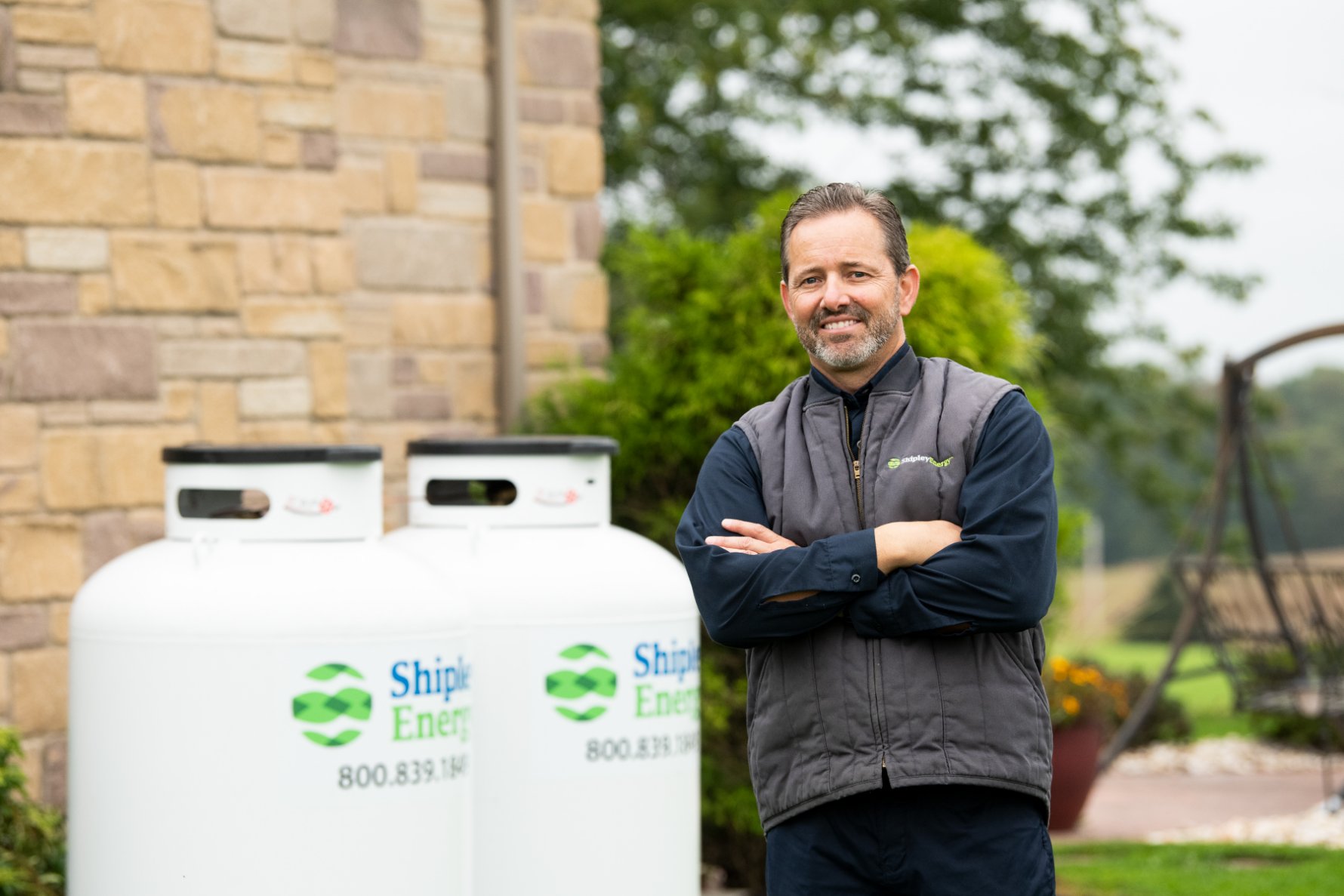 shipley energy employee standing by propane tank